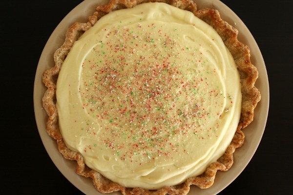 overhead view of a peppermint mousse pie topped with crushed peppermint candies