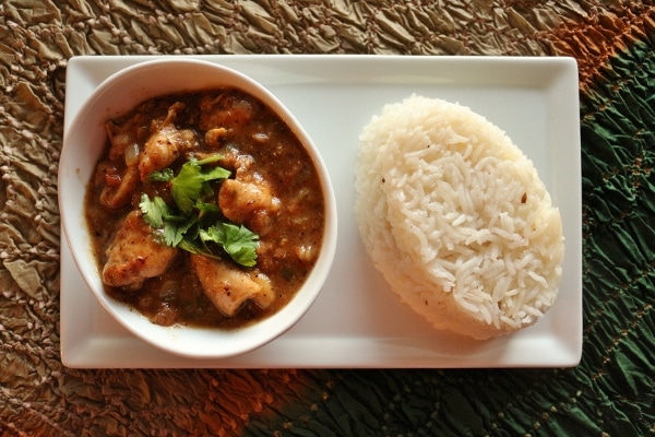 overhead view of a bowl of Cape Malay chicken curry with a scoop of rice