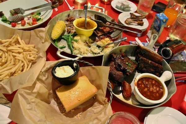 a view of the dining table topped with various dishes of food