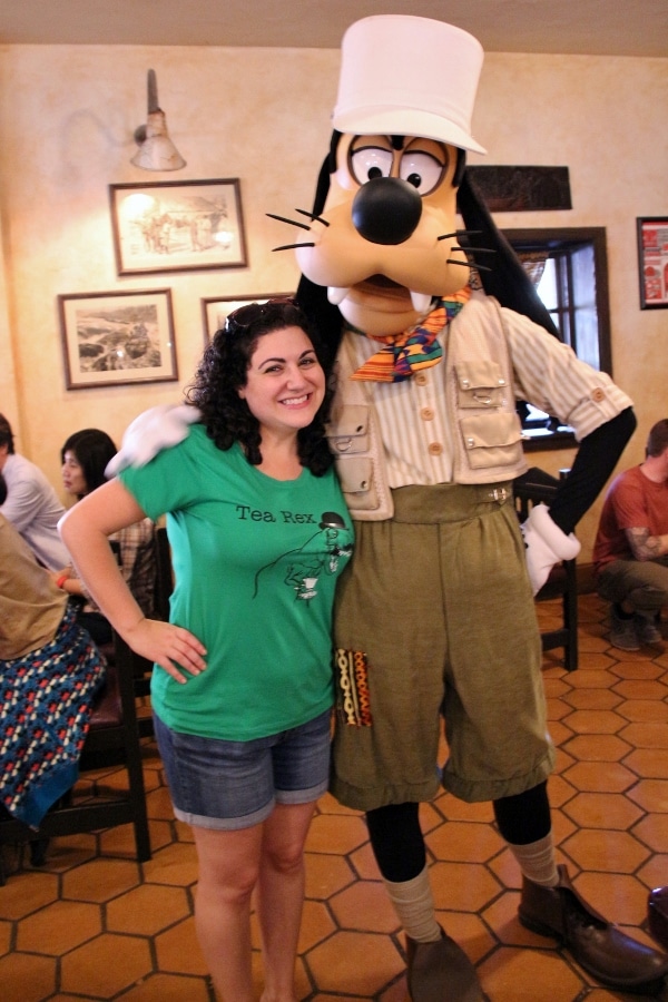 a woman posing with Goofy