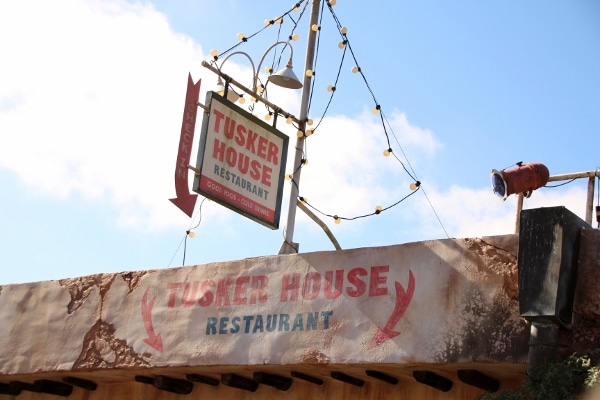 A close up of a sign that says Tusker House Restaurant