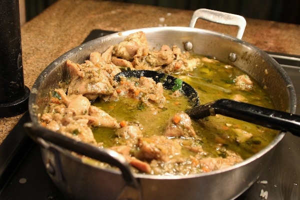 chicken curry with a green sauce on a buffet line