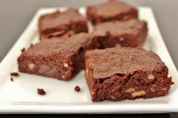 side view of a plate of brownies with walnuts and chocolate chips