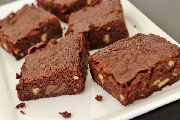 a plate of brownies with walnuts and chocolate chips