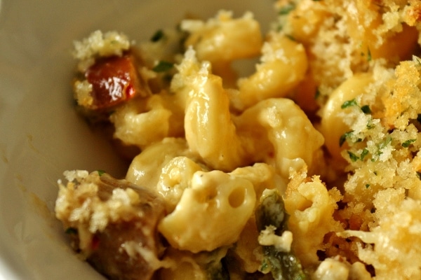 a super closeup of a bowl of mac and cheese with chorizo and poblanos
