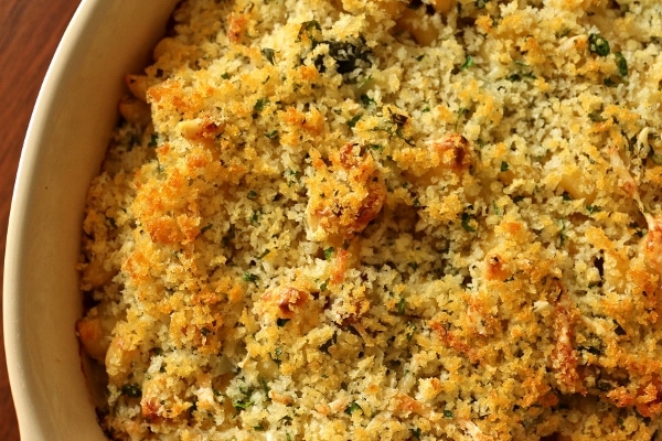 A close up of a baking dish of macaroni and cheese with a golden panko crust