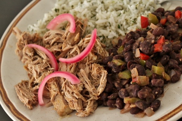 slow-cooked mojo pork with black beans, cilantro rice, and pickled red onions