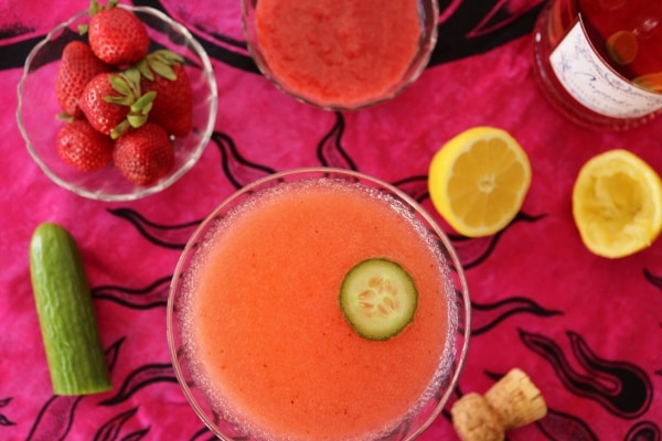 overhead view of a pink cocktail surrounded by various ingredients