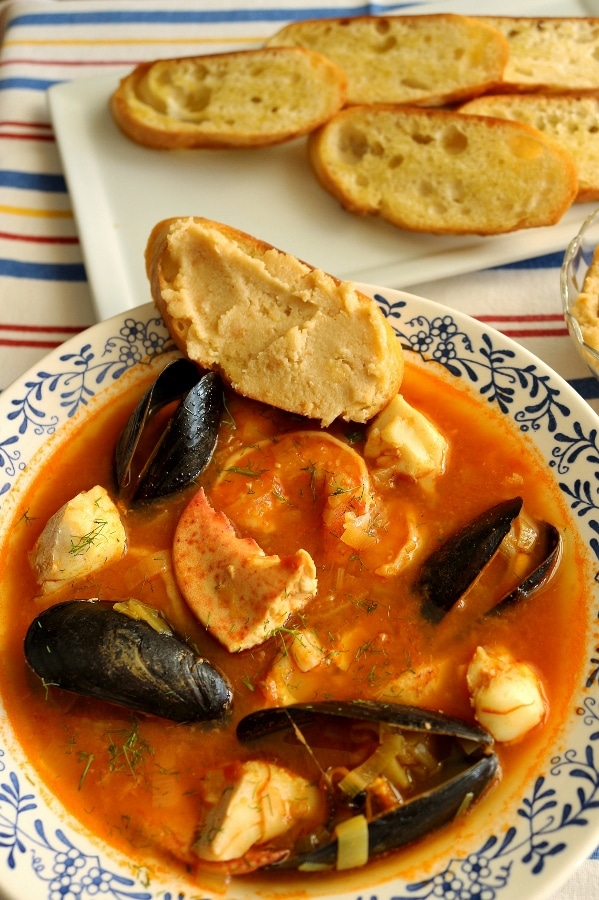 a bowl of bouillabaisse seafood stew with mussels, fish, and lobster