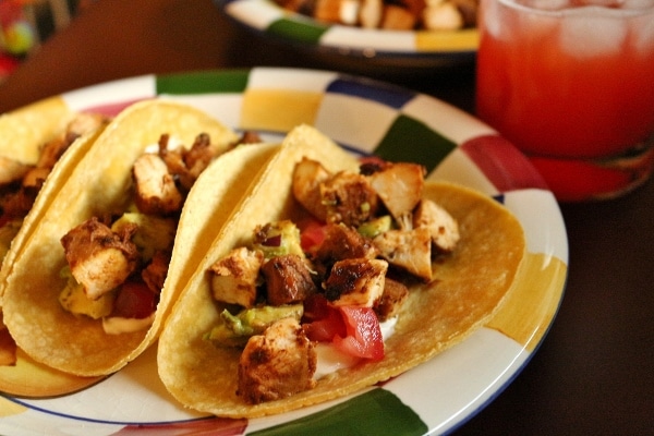 A close up of a plate of chicken tacos