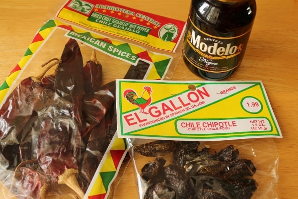 Packages of dried chiles, and a bottle of Modelo Negro Mexican beer