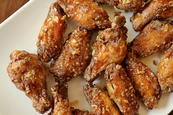 overhead view of fried Saigon chicken wings on a white platter