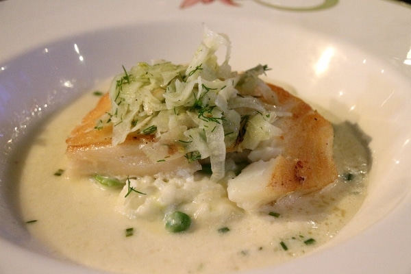 a fillet of fish over green pea risotto