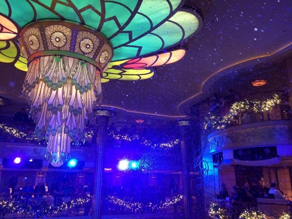 fake snow falling inside the Disney Fantasy\'s lobby atrium