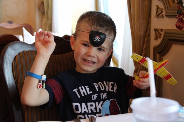 A little boy with an eye patch on his forehead