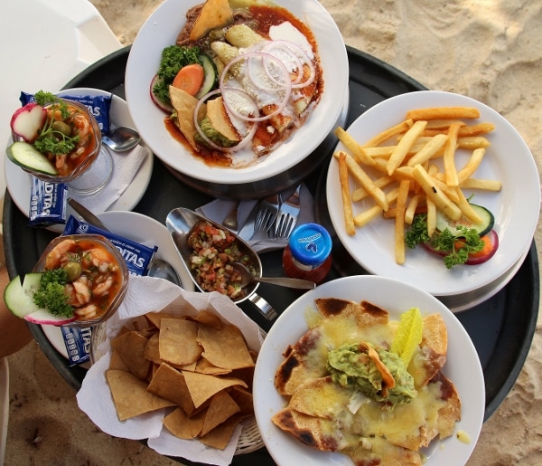 overhead view of plates of food on a large plastic tray