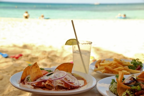 plates of food with the beach in the background