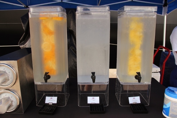 a row of water coolers, some infused with fruit