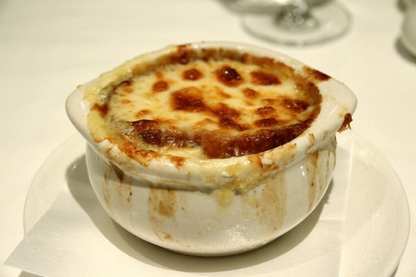 a bowl of French onion soup topped with bubbly cheese