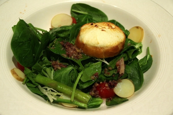 salad with a goat cheese crouton on top