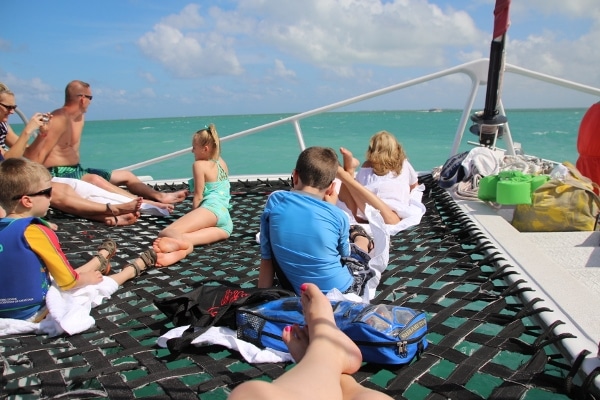 A group of people sitting on a catamaran