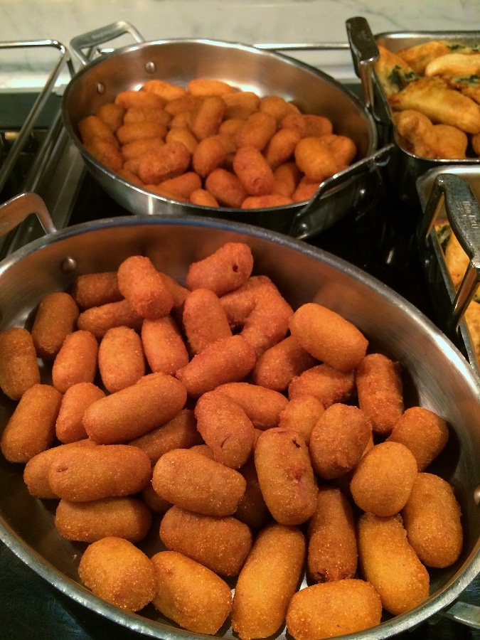 trays of mini corn dogs on a buffet