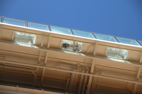 view looking up at a boy looking down through a glass floor