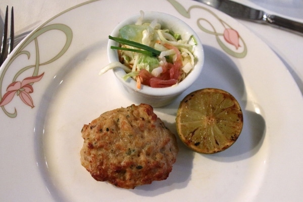 a crab cake with a side of slaw