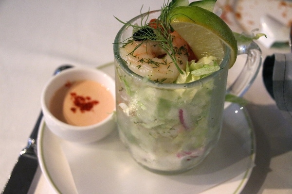 A cup of salad topped with shrimp