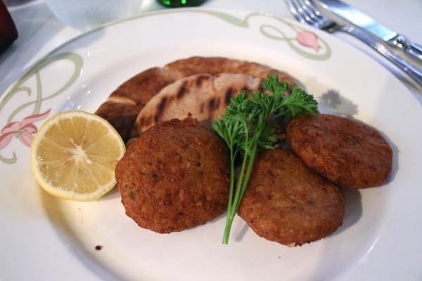 A plate of falafel cakes with pita bread