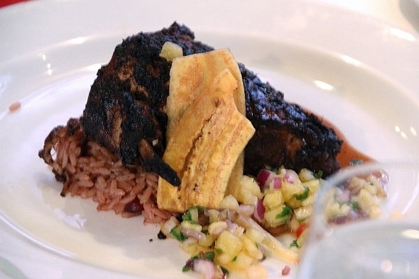 a plate of blackened chicken with rice