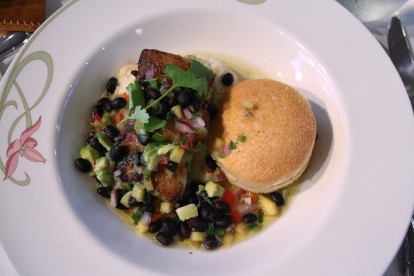 A plate of fish with beans and corn