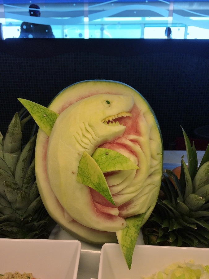 a carving of a shark in a watermelon