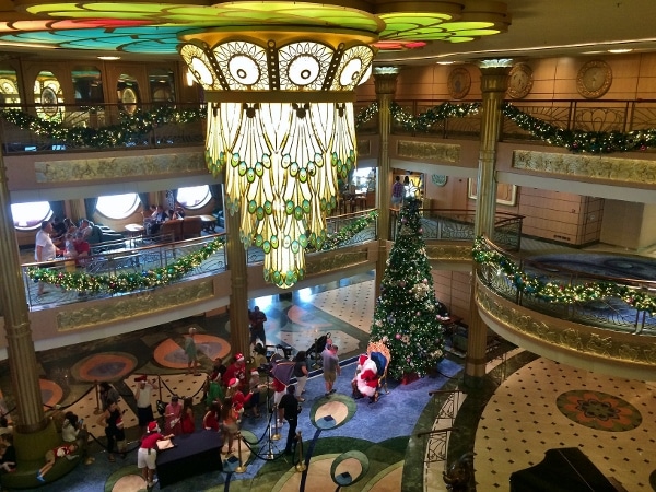 overhead view of Santa greeting guests in the Disney Fantasy lobby atrium