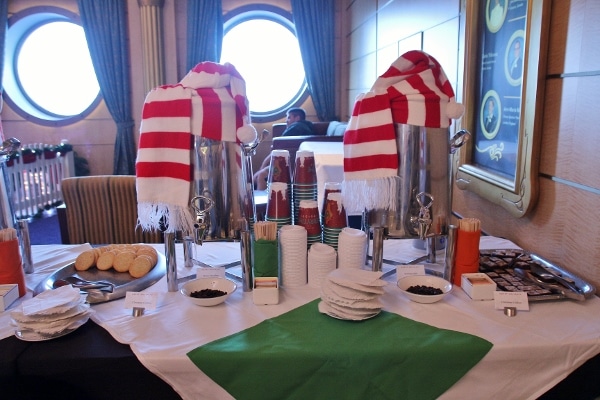 hot drink dispensers covered with striped scarves and hats