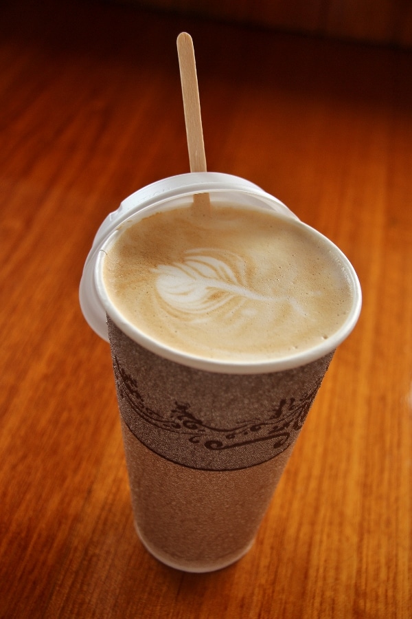 a latte in a disposable cup