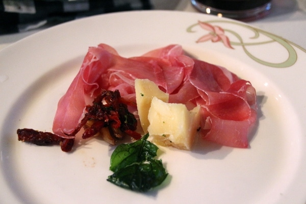 a plate of prosciutto and cheese