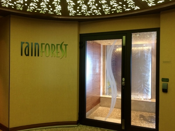 a sign that says Rainforest next to a glass door