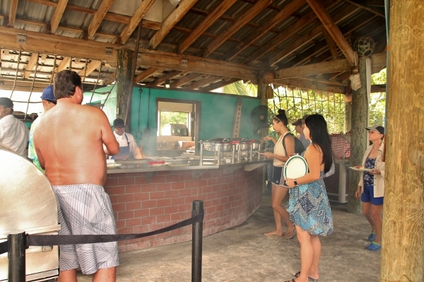 A group of people standing in line at a buffet