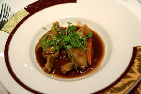 pasta parcels in a dark brown sauce