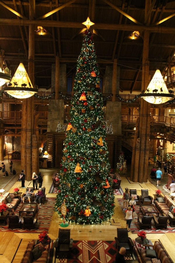 nighttime view of the giant Christmas tree in Disney\'s Wilderness Lodge lobby