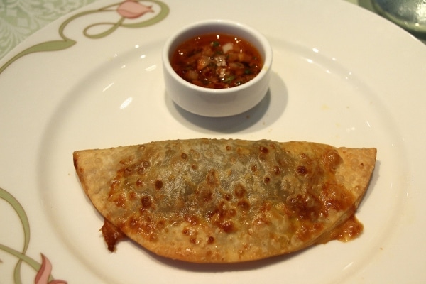 a fried beef empanada on a plate