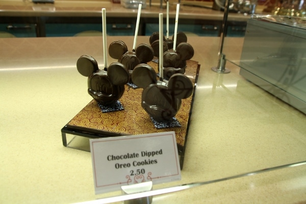 a display of chocolate dipped Oreo cookies that look like Mickey Mouse