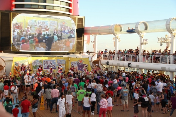 A crowd of people standing on the upper deck of the Disney Fantasy