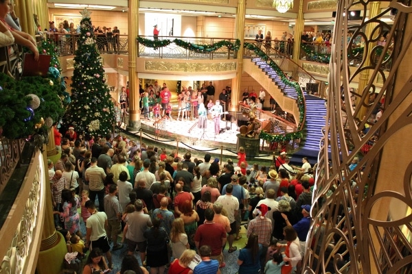 A large crowd of people in the Disney Fantasy lobby atrium