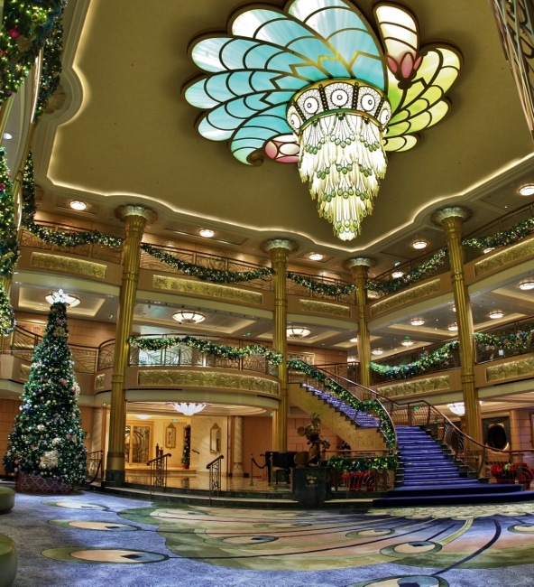 a wide view of the Disney Fantasy\'s lobby atrium decorated for Christmas