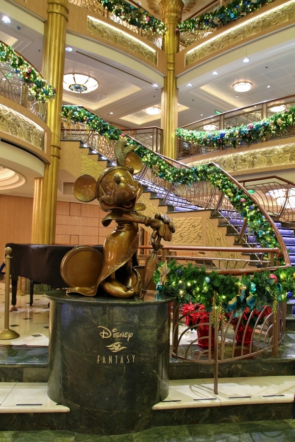 a closeup of a Minnie Mouse statue in the Disney Fantasy\'s lobby atrium