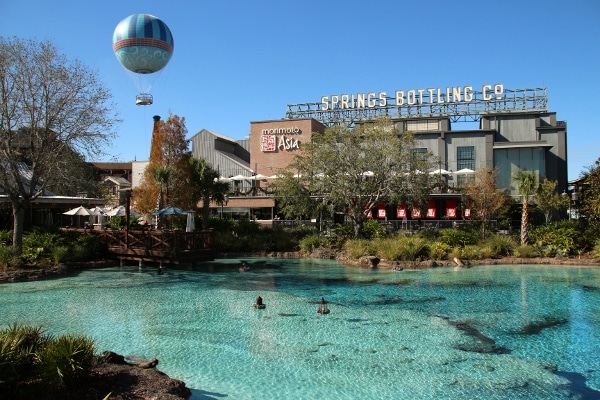 A pool of water in front of a building that says Springs Bottling Co