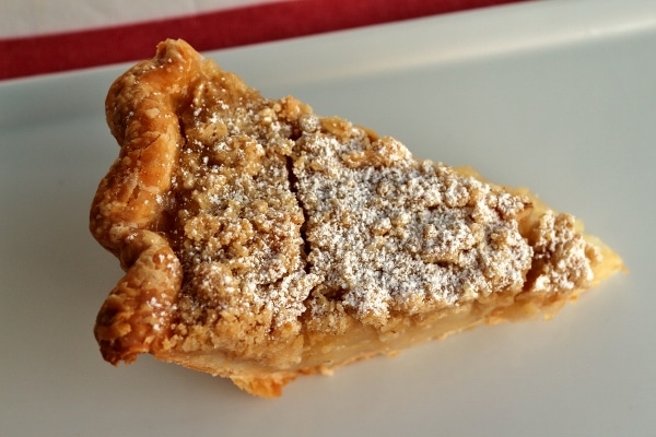 overhead view of a slice of pie with powdered sugar dusted over the top