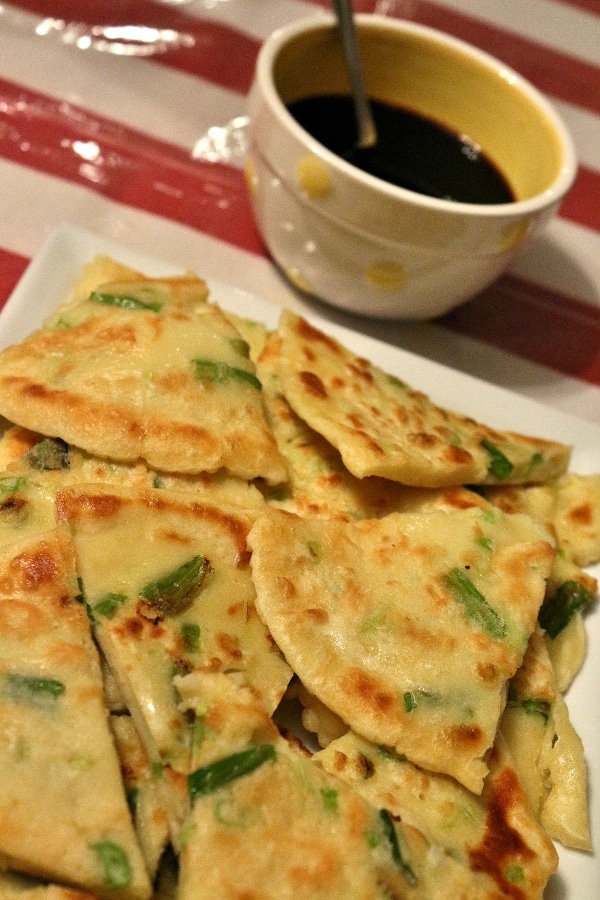 A close up of a platter of pajeon scallion pancakes